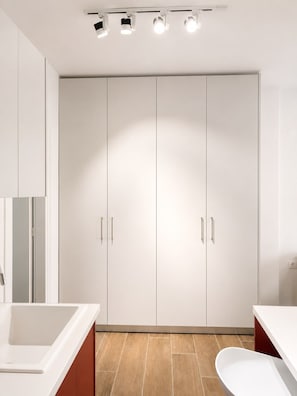 A modern bathroom with a large white vanity, a toilet, and a double wardrobe with handles. - Quiet City Studio w/ Kitchen near Ladadika (Thessaloniki)