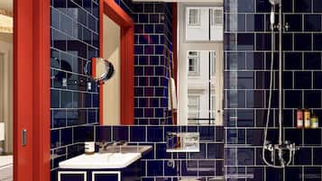 A modern bathroom with a toilet, sink, and shower.