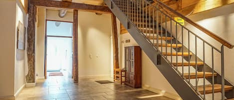 A staircase with a metal railing leading to an upper floor.