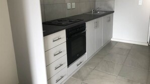 Una cocina con estufa, horno y pileta.