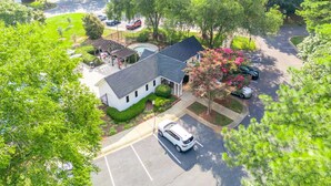 A residential area with a house, a swimming pool, and a parking lot. - Garden by the University (Charlotte)