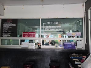 An office area with a sign indicating 'OFFICE INFORMATION' and a list of rules on the wall. - Jiranakron Park (Mueang Buriram)