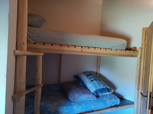 A bunk bed with a lower bunk and a mattress with a floral pattern.