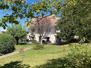 A residential property with a well-maintained lawn, a pathway leading to the entrance, and a two-story house with a balcony. - Holiday Home in Trevigin With Wi-fi (Trevignin)