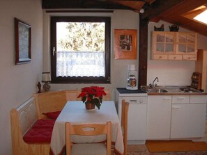 A compact kitchen with a dining table, a coffee maker, and a sink. - "vienna Woods" Am Wiesengrund (Vienna)