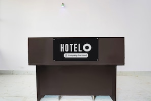 A black sign with 'HOTEL' and 'Company Serviced' text, mounted on a brown stand. - Hotel O Garden View Vrindavan Lucknow (Lucknow)