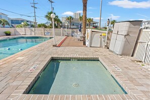 A swimming pool with a no lifeguard sign, a diving board, and a deck area with chairs and tables. - Couples Getaway 105 -1BR Gold Coast, Cherry Grove (North Myrtle Beach)