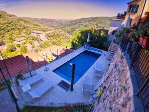 A rooftop swimming pool with a view of a hilly landscape. - Holiday Home With 3 Bedrooms (Pietrabruna)