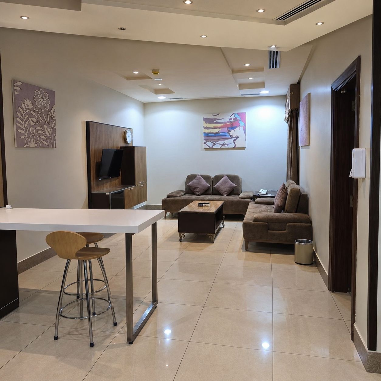 A modern living room with a sofa, a coffee table, and a TV.