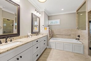 A modern bathroom with a double sink vanity, a large mirror, a bathtub, and a shower enclosure. - Sea Rest | Private Pool | Deeded Beach Access | 3 King Suites (Watersound Beach)