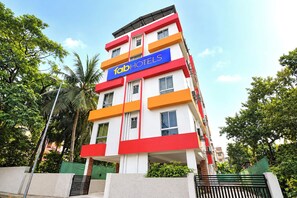 A multi-story building with a prominent 'hotels' sign, featuring balconies and a modern architectural design. - FabHotel Love Point (Barasat)