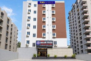 A hotel with a modern facade, air conditioning units, and a sign indicating 'Dream Pride Luxury Rooms.' - Fabhotel Dream Pride (Hyderabad)