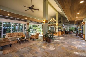 A spacious lobby with a high ceiling, large windows, and a reception desk. - Mahana at Kaanapali Studio Ocean Front - No Cleaning Fees (Lahaina)