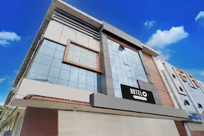 A modern hotel building with a prominent sign reading 'HOTEL O'.
