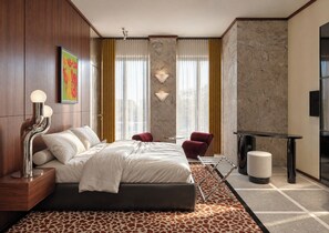 A modern hotel room with a bed, a desk, a chair, and a TV. - The Couper Torretta (Roma)