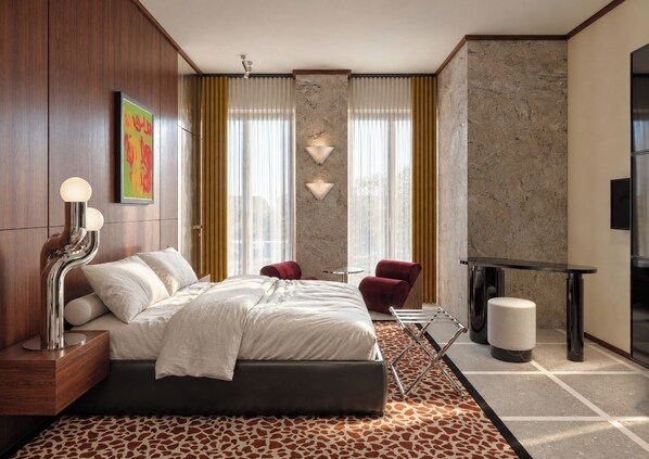 A modern hotel room with a bed, a desk, a chair, and a TV. - The Couper Torretta (Roma)