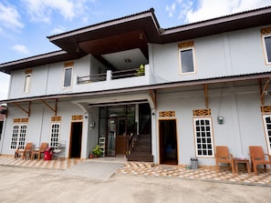 A two-story building with a balcony, a staircase, and a tiled entrance area. - Hotel O near Pantai Manggar (Samboja Kuala)