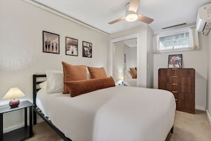 A bedroom with a bed, a nightstand, a dresser, a ceiling fan, and wall-mounted pictures. - Scribners Retreat | Sleeps 6 | Huge Patio/Jacuzzi (Tannersville)