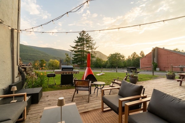 A patio with outdoor furniture, a grill, and a red chimney. - Scribners Retreat | Sleeps 6 | Huge Patio/Jacuzzi (Tannersville)