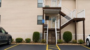 A two-story building with a parking lot in front. - Sunset Shores Lakefront Views Pool and Lakeview (Lake Ozark)