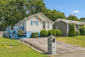 A residential property with a driveway, a mailbox, and a blue play structure. - Iconic Music City retreat w/ backyard and hot tub! (Nashville)