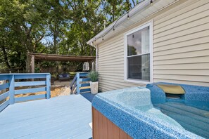 A covered outdoor area with a hot tub, wooden deck, and a pergola. - Iconic Music City retreat w/ backyard and hot tub! (Nashville)