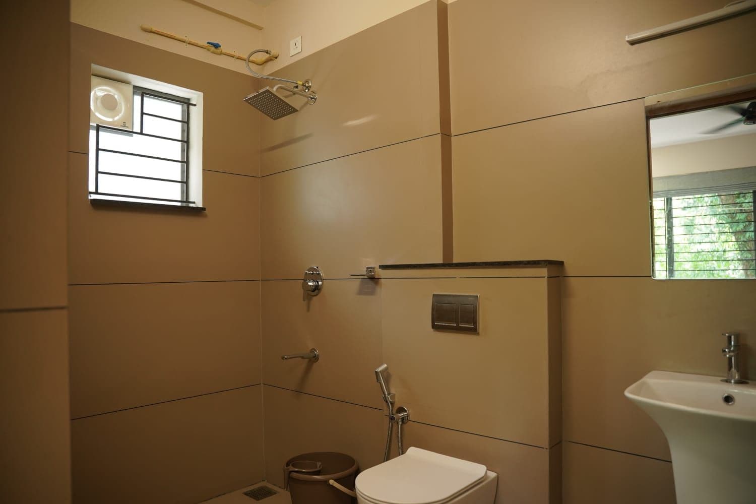 A bathroom with a shower, toilet, and sink.