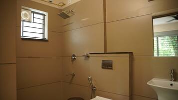 A bathroom with a shower, toilet, and sink.