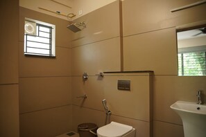 A bathroom with a shower, toilet, and sink.