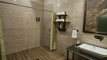 Een moderne badkamer met een douche, toilet en wastafel.
