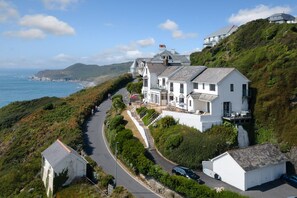 A coastal property with a main house and a smaller building, connected by a winding road. - Sunnycliffe House (Woolacombe)