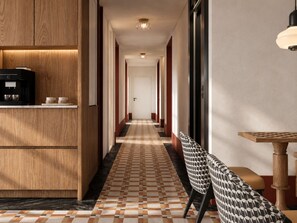 A hotel hallway with a coffee machine, a bench, and a table. - Axis.Bangkok Chess (Bangkok)
