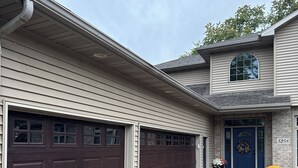 A two-story house with a garage, a front door, and a mailbox. - EAA Exquisite 6-bedroom 3.5 bathroom house w AC on water only 8 minutes from EAA (Oshkosh)