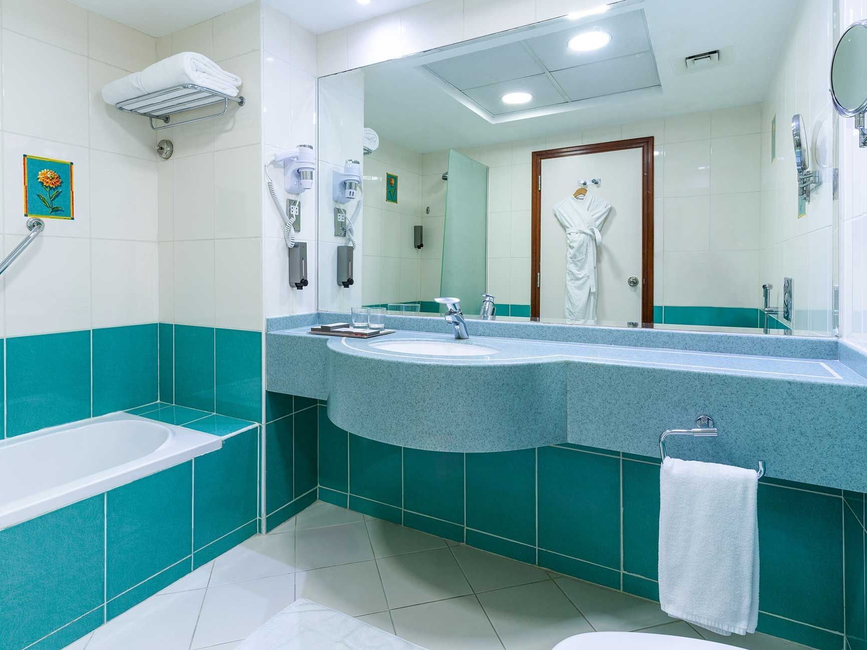 Ein modernes Badezimmer mit einer Badewanne, einem Waschbecken und einem großen Spiegel.