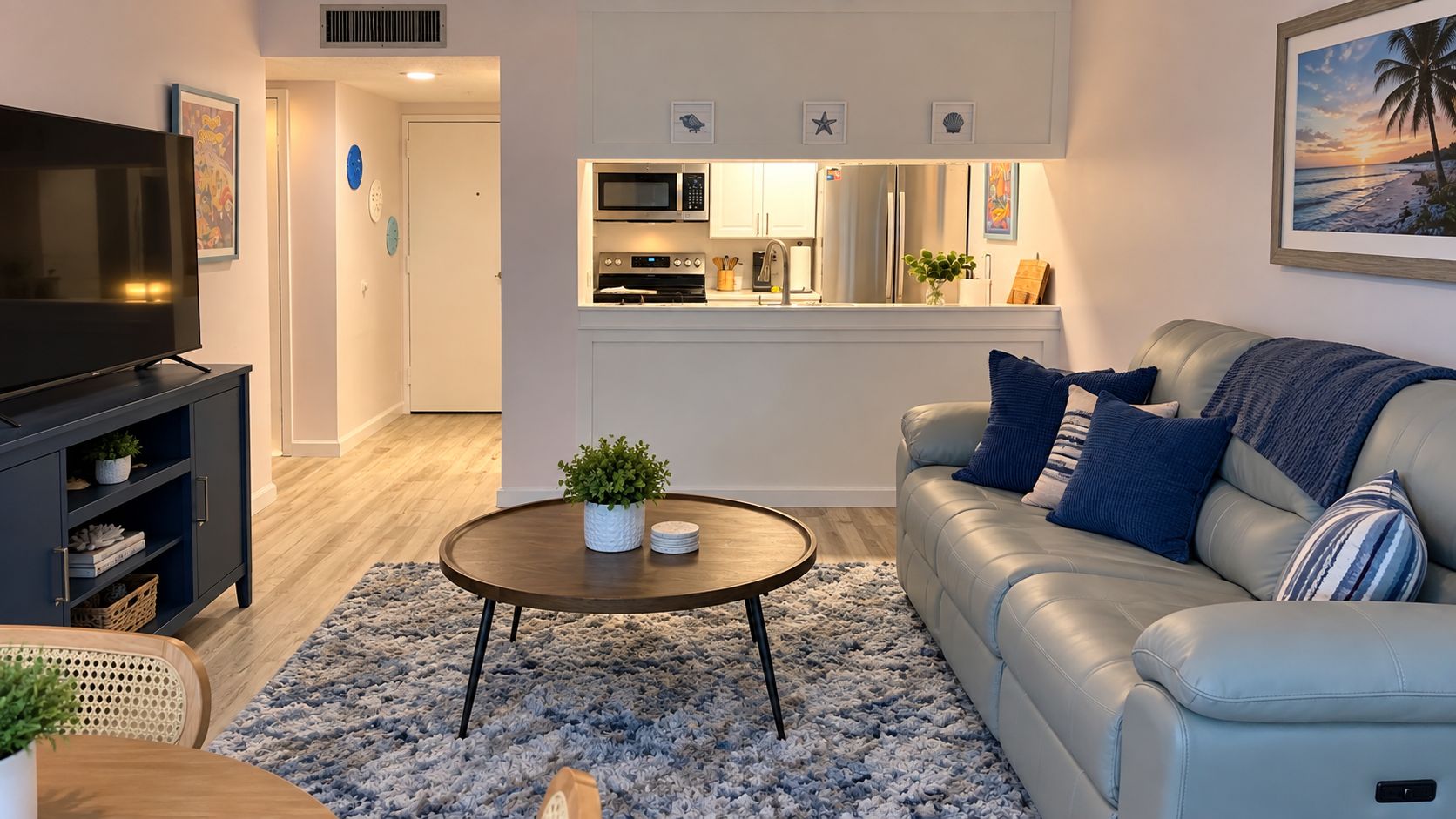 A modern living room with a sofa, coffee table, and a television.