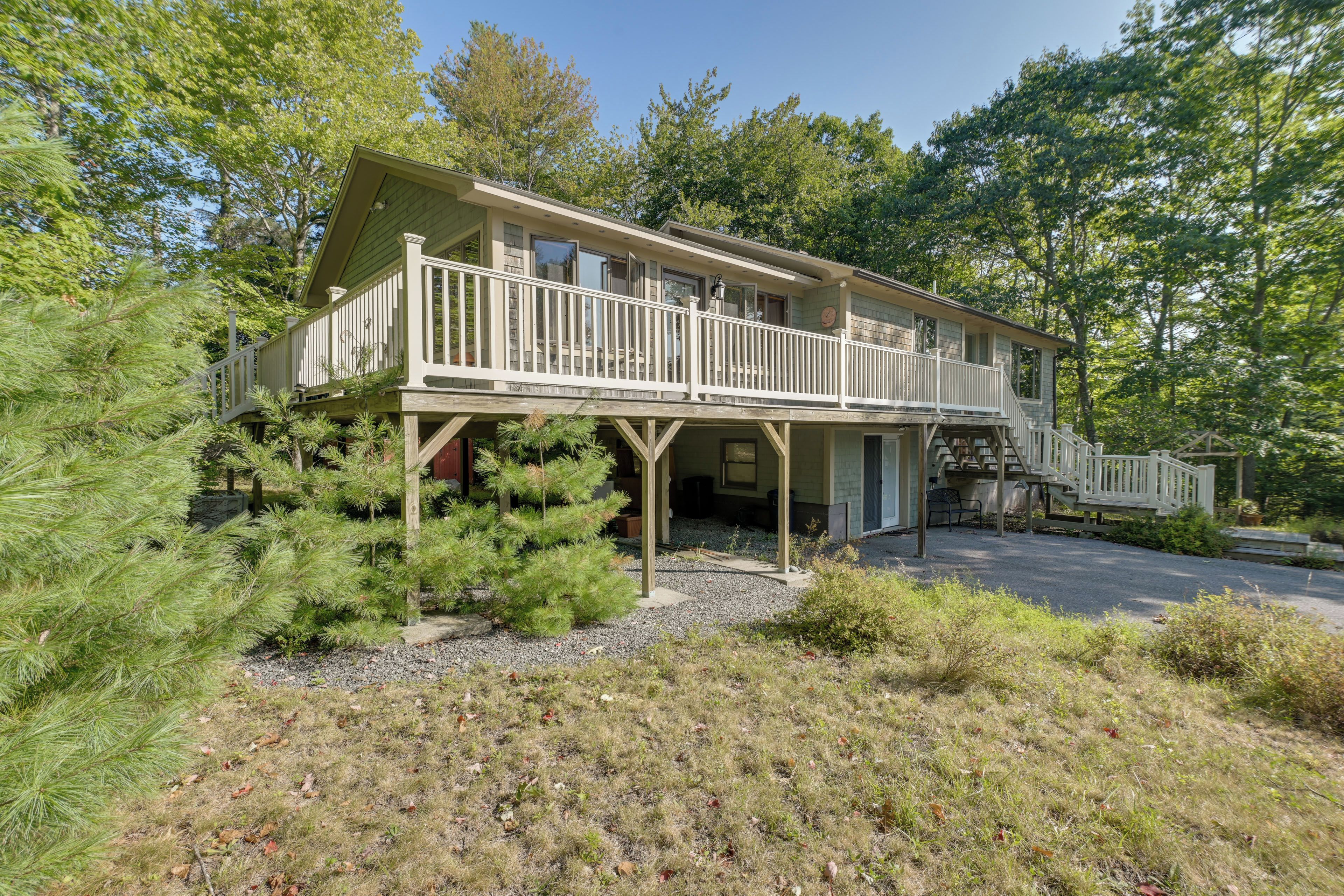 A two-story house with a balcony and a covered porch.