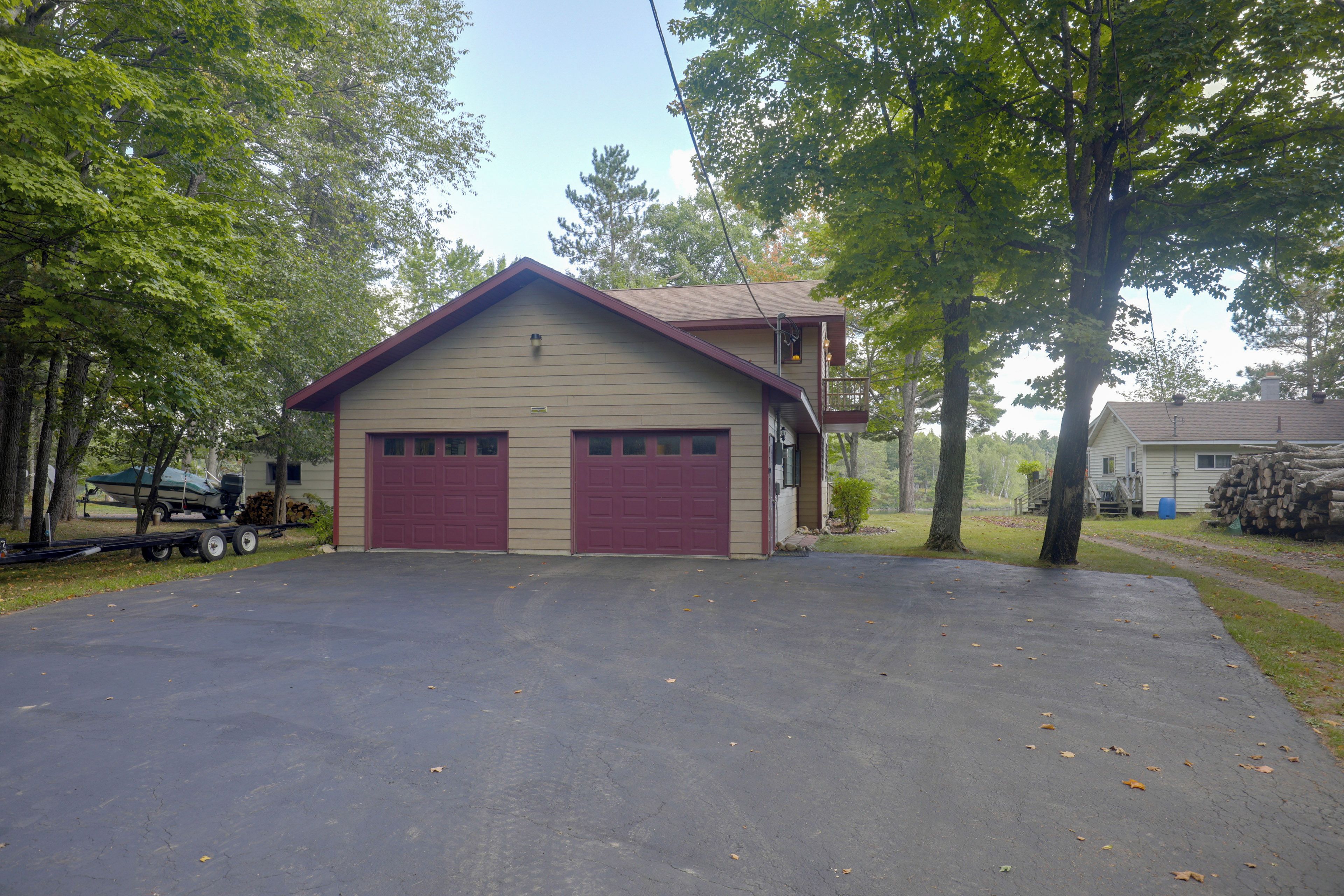 A two-story building with a garage and a covered porch.