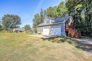 A single-story house with a garage, a covered patio, and a wooden deck. - Fire Pit + Yard: Peaceful Nottoway County Apt (Blackstone)