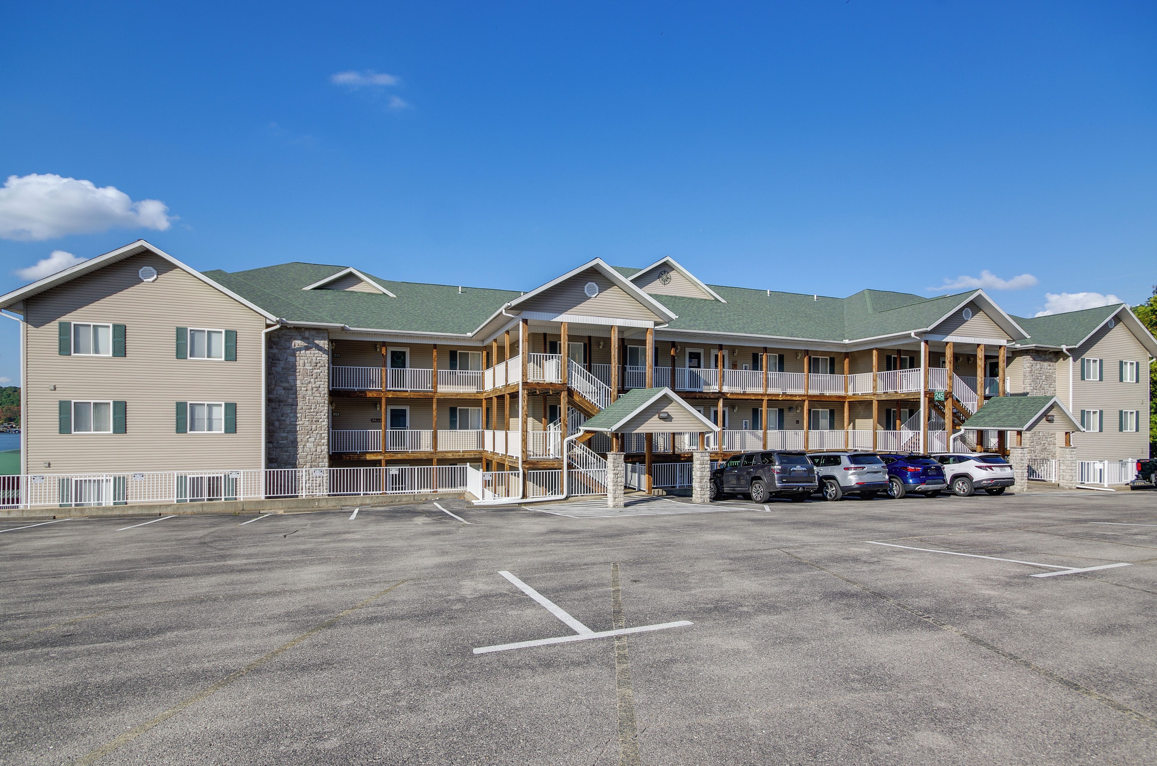 A multi-story hotel with a parking lot in front.