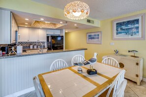 A kitchen with white cabinets, a built-in oven, and a granite countertop. - Oceanfront Paradise on No-drive New Smyrna Beach (New Smyrna Beach)