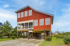 A two-story building with a balcony and a covered outdoor area. - Walk to Ocean! Family Condo in North Topsail Beach (Sneads Ferry)