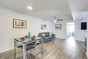 A modern living space with a dining area, a sofa, and a television. - 2 Mi to University of Florida! Unit w/ Pool Access (Gainesville)