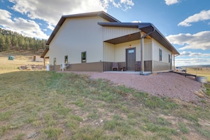 A large, single-story building with a flat roof and a covered porch area. - Trail Access & Views! 90-acre Haven in Hot Springs (Hot Springs)