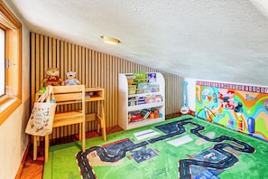 A child's playroom with a bookshelf, stuffed toys, and a colorful alphabet mural. - Deck & Views! Family Retreat Near Rmnp (Grand Lake)