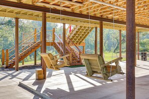 A wooden deck with a swing set and a staircase leading to a higher level. - 'river Bank' Spacious Waterfront Group Getaway (Nashville)