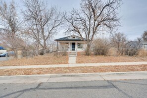 A small, single-story house with a front porch and a fenced yard. - Spacious Duplex Duo: 14 Mi to Pearl Street Mall (Erie)