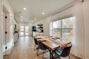 A modern kitchen with white cabinets, a wooden countertop, and a large window. - Spacious Duplex Duo: 14 Mi to Pearl Street Mall (Erie)