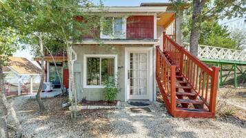 A two-story house with a red staircase and a small porch.