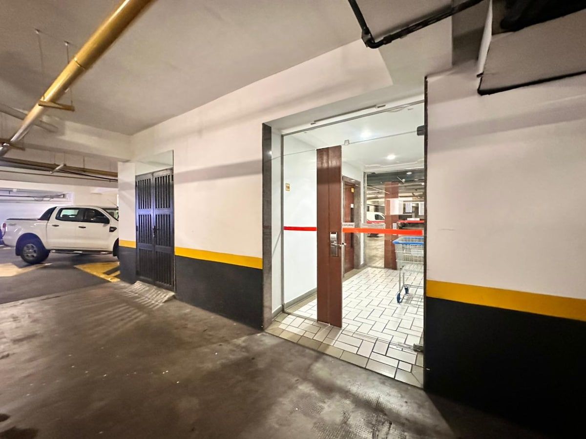 A parking garage with a white pickup truck parked in the foreground.