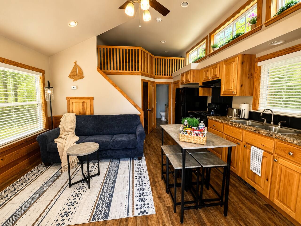 A cozy living room with a sofa, a coffee table, and a patterned rug.